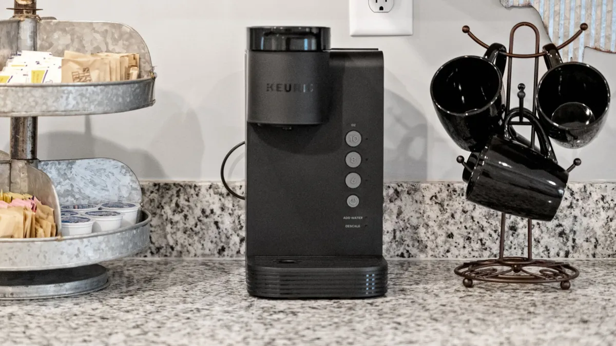 This image features a coffee machine, a well-stocked sugar and cream station, and a mug holder, all arranged on a countertop. The setup is inviting and clearly designed for enjoying a morning beverage, with soft natural light suggesting proximity to a window or outdoor area.